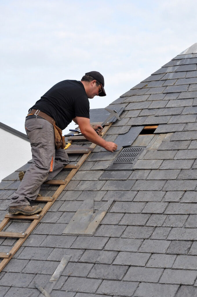 roofer fixing roofing shingles